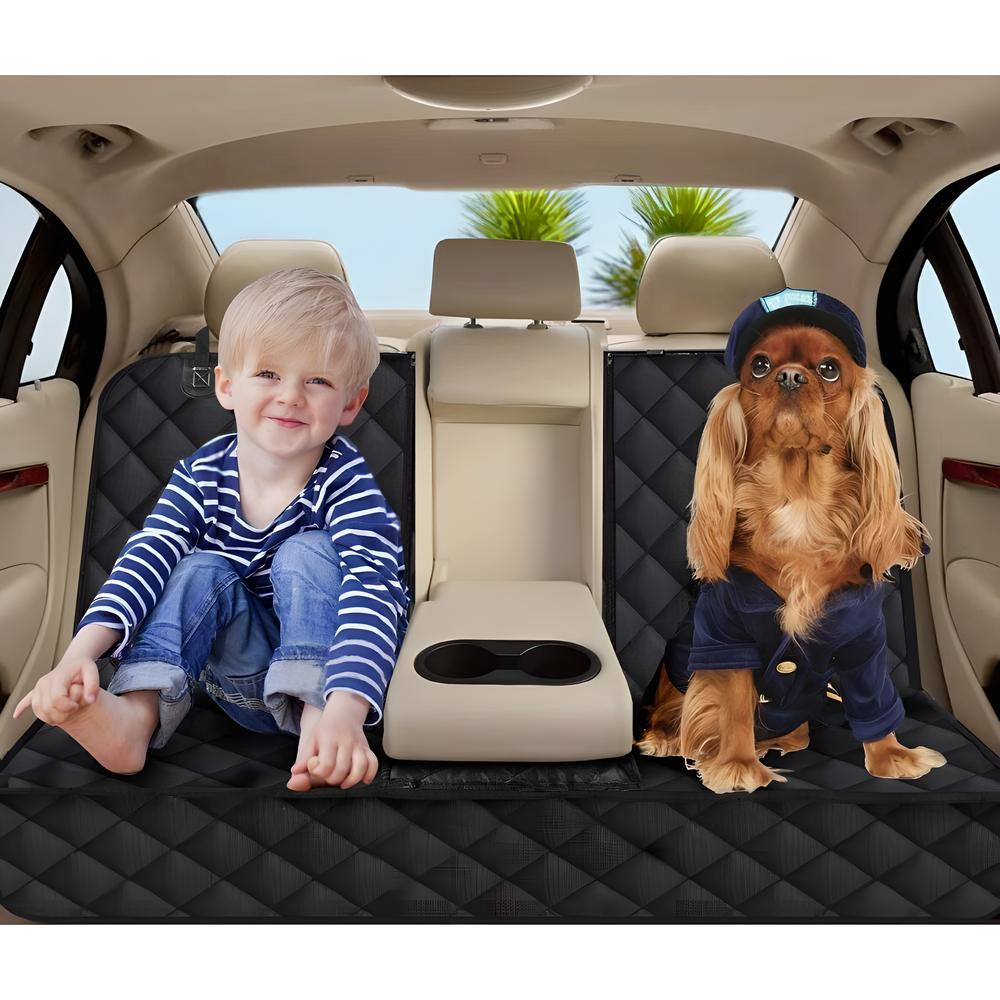 A young boy sits in a waterproof dog car seat cover for the back seat with armrest access.