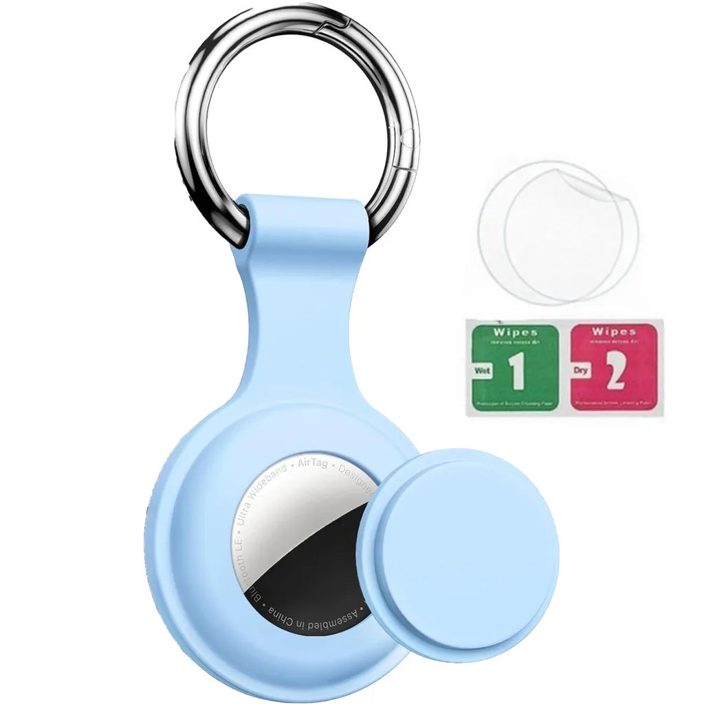 Light blue silicone protective cover for an AirTag with a metal keychain ring and cleaning wipes.