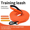 Orange training leash coiled and ready for customization, featuring a padded handle and adjustable length.