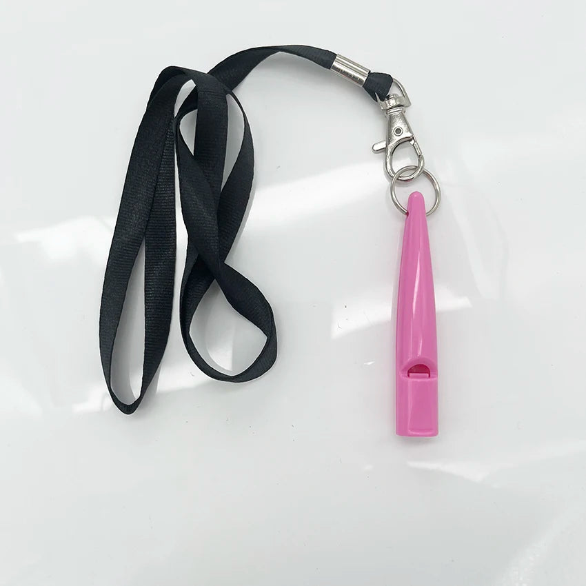 A pink ultrasonic dog whistle attached to a black lanyard and clip.