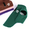 A green fleece dog sweater with a paw print design is shown next to stacked sweaters in brown, pink, and purple.