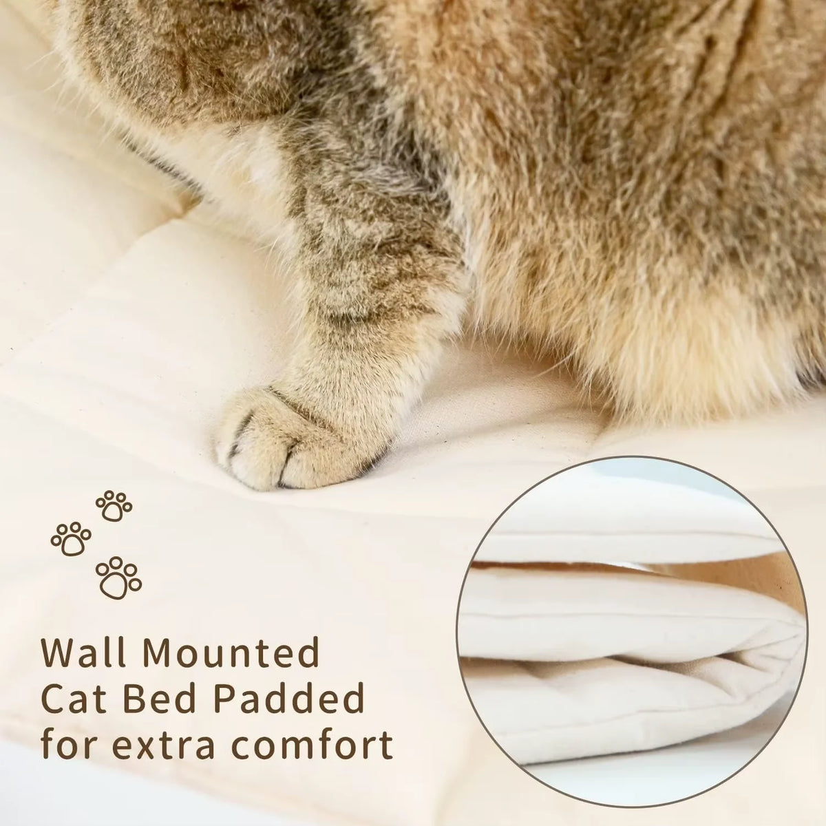 A fluffy tabby cat is resting on a cream-colored fabric, demonstrating the comfort of a wall mounted cat bed.