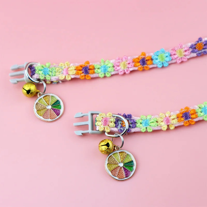 A colorful lace pet collar with a floral pattern and a gold pendant for small dogs and cats.