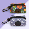 A pair of stylish fabric poop bags holders in floral and gray patterns with black zippers and metal loops.