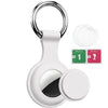 White silicone AirTag protective cover with a metal keychain ring and cleaning wipes