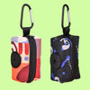 A black and multi-colored fabric poop bag holder with a loop for leash-free dog cleanup.