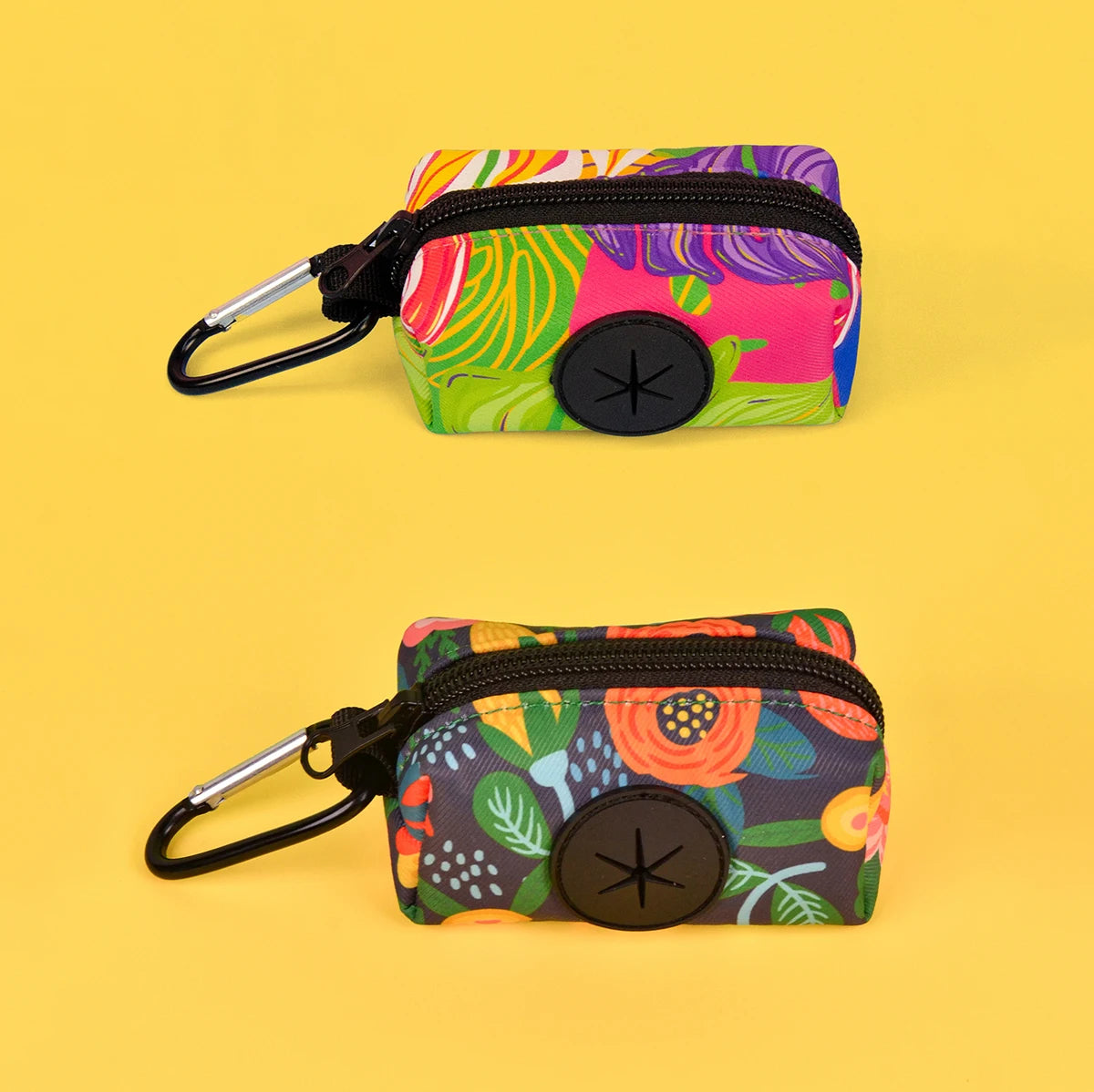 A colorful, patterned fabric pouch with a black strap and buckle is shown against a yellow background.