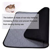 A black non-slip fleece cage liner with a gray honeycomb pattern, shown next to a small rodent.
