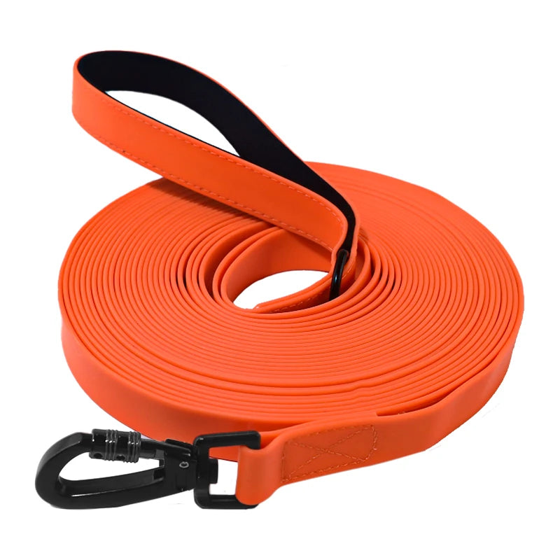 Orange waterproof PVC dog training leash with a padded handle rolled up and attached to a clip.
