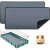 Gray reusable non-slip fleece cage liner with a hexagonal pattern and a clear wire enclosure for small pets