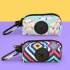 A light blue patterned pouch designed to hold dog poop, featuring a black magnetic closure and attached to a leash.