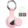 Pink silicone protective cover for an AirTag with a metal keychain ring and cleaning wipes