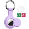 A purple silicone protective cover for an AirTag attached to a metal keychain ring.