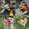 A dog is playing with a green plush beer bottle toy and a black bottle toy.