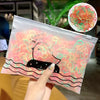 A clear plastic bag containing colorful disposable elastic hair bands and a circular display of the same product.