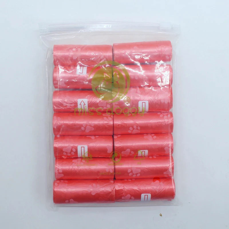 A pack of 14 rolls of pink paw print dog waste bags with a dispenser.