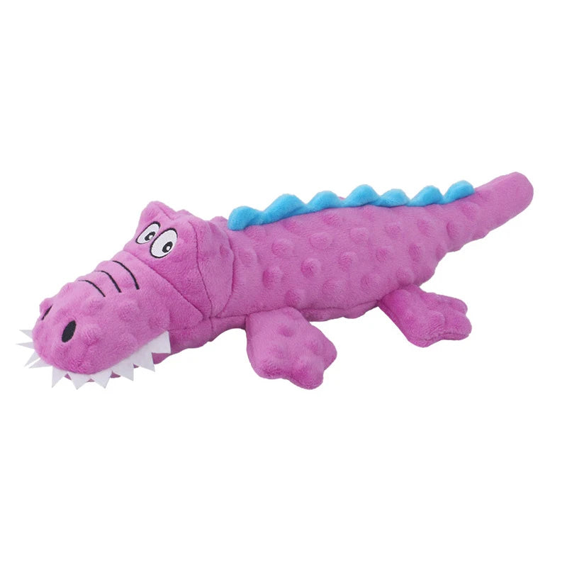 A purple and blue plush toy of a sea turtle with a spiky dorsal fin.