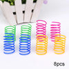 Eight colorful spiral spring toys in green, blue, pink, yellow, and purple for cats and ferrets