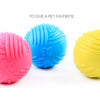 Three brightly colored rubber chew toys in pink, blue, and yellow are displayed against a white background.