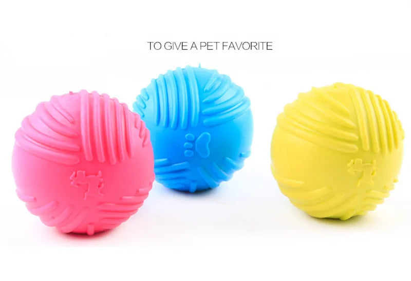 Three brightly colored rubber chew toys in pink, blue, and yellow are displayed against a white background.