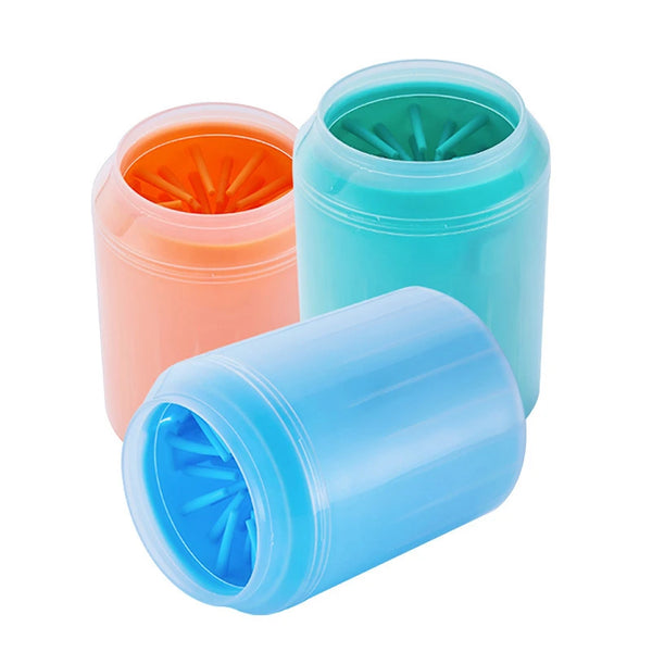 Three silicone pet paw cleaner brushes in orange, teal, and blue stacked together.