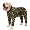 A golden retriever wearing a camouflage print jumpsuit.