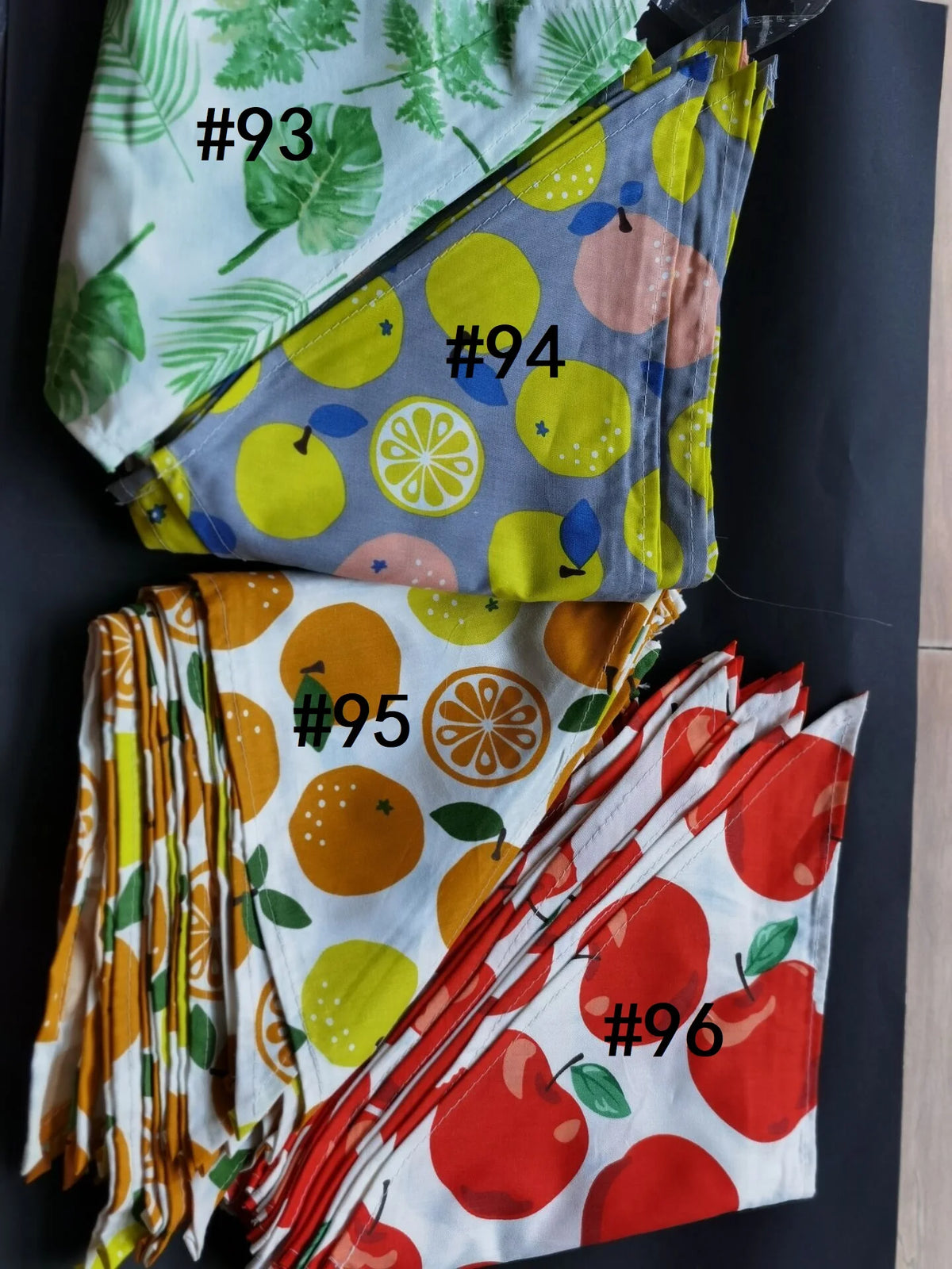A collection of nine colorful cotton pet bandanas for dogs and cats, numbered 93 through 96.