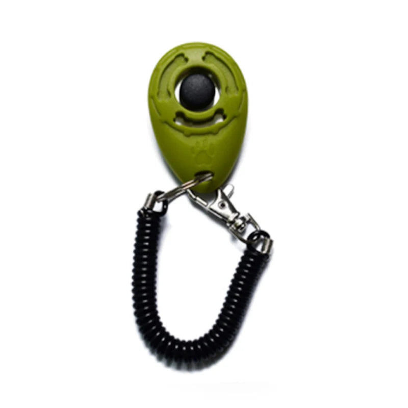 A bright lime green pet training clicker with a black eye and attached to a black wrist strap.