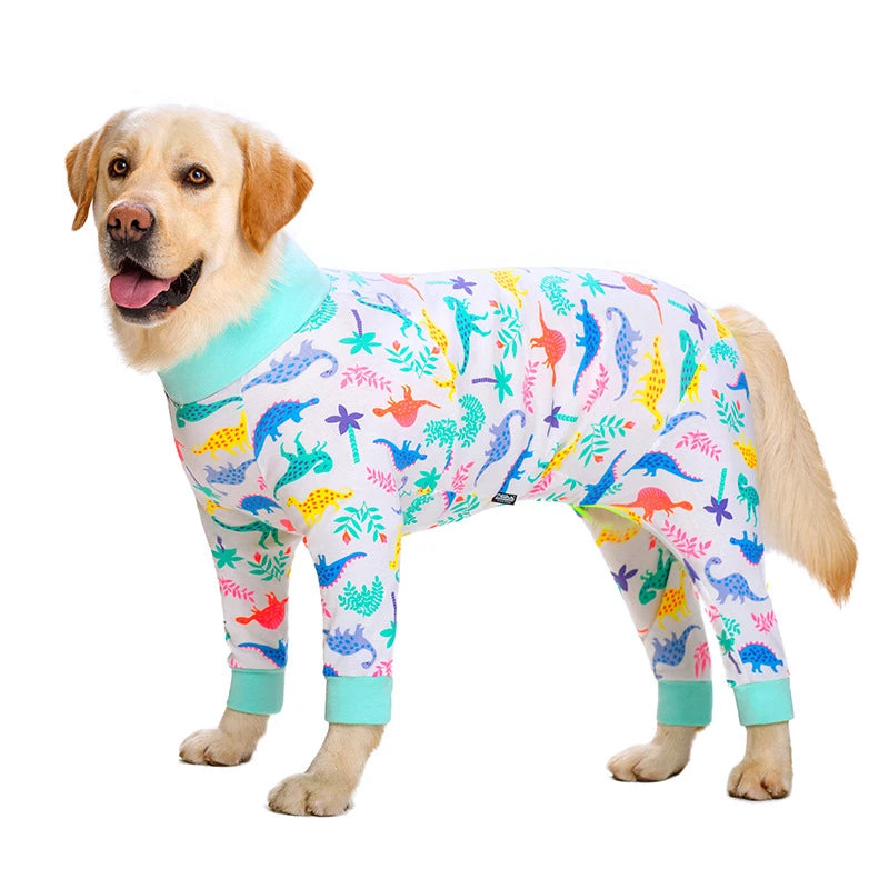 A golden retriever wearing a colorful cartoon animal print jumpsuit.