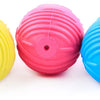 Three brightly colored rubber chew toys for small dogs in yellow, pink, and blue.