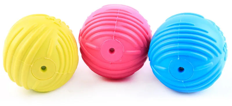 Three brightly colored rubber chew toys for small dogs in yellow, pink, and blue.