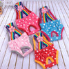 A collection of colorful, polka-dot physiological dog underwear for females in pink, purple, blue, and red.