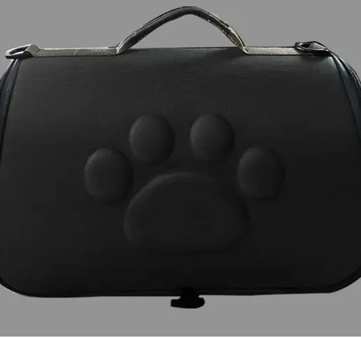 Black leather pet carrier bag featuring a paw print design and a handle.