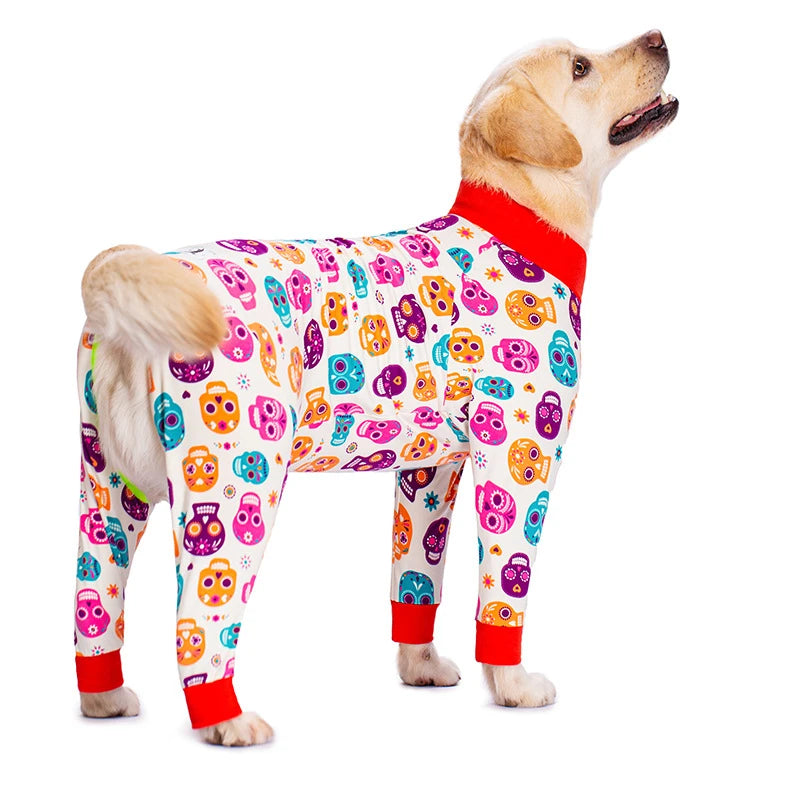A golden retriever wearing a colorful cartoon animal print jumpsuit with red trim.