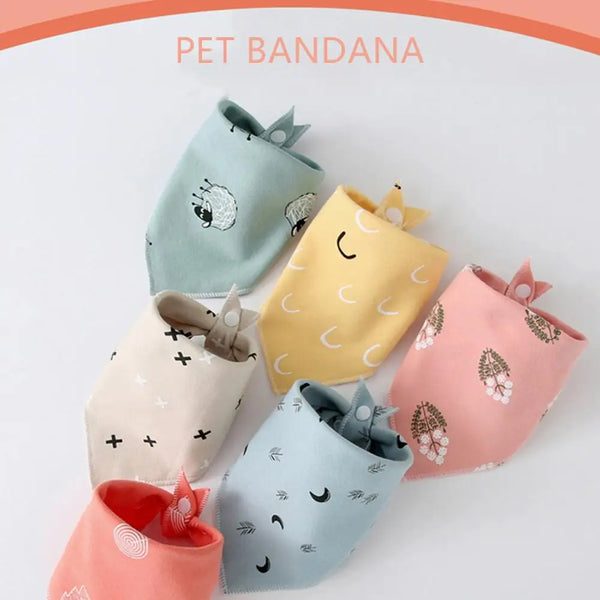 A collection of soft cotton pet bandanas in various pastel colors and patterns, including green, yellow, pink, and light blue
