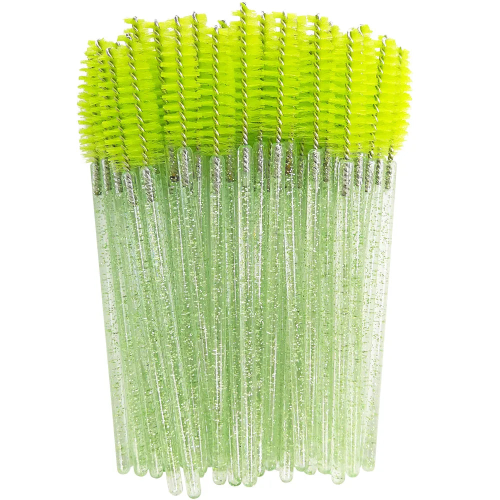 A bundle of disposable green eyelash brushes with bright yellow bristles.