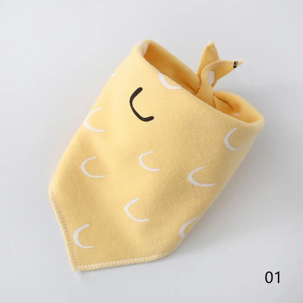 A yellow cotton pet bandana with a simple stitched face design.