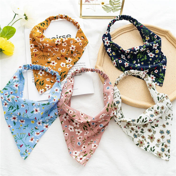 A collection of five bohemian paisley triangle head scarves in various floral patterns and colors.