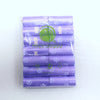 A pack of 14 rolls of purple paw print dog waste bags with a dispenser.