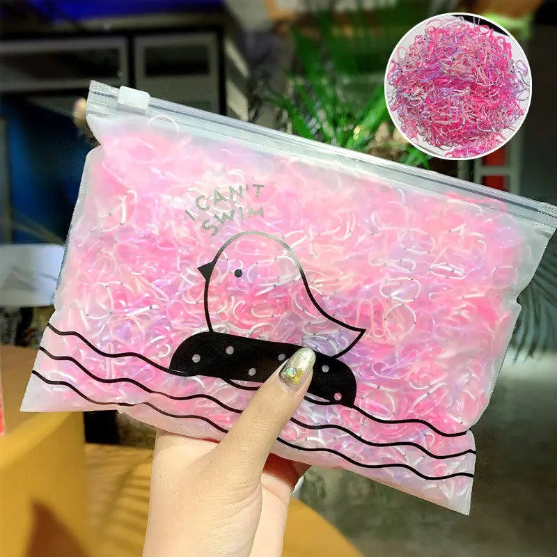 A clear plastic bag filled with pink and white colorful disposable elastic hair bands featuring a duck design.