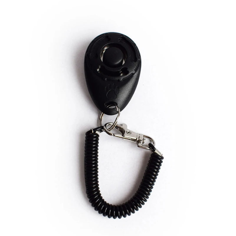 Black adjustable pet training clicker with a nylon wrist strap attached.