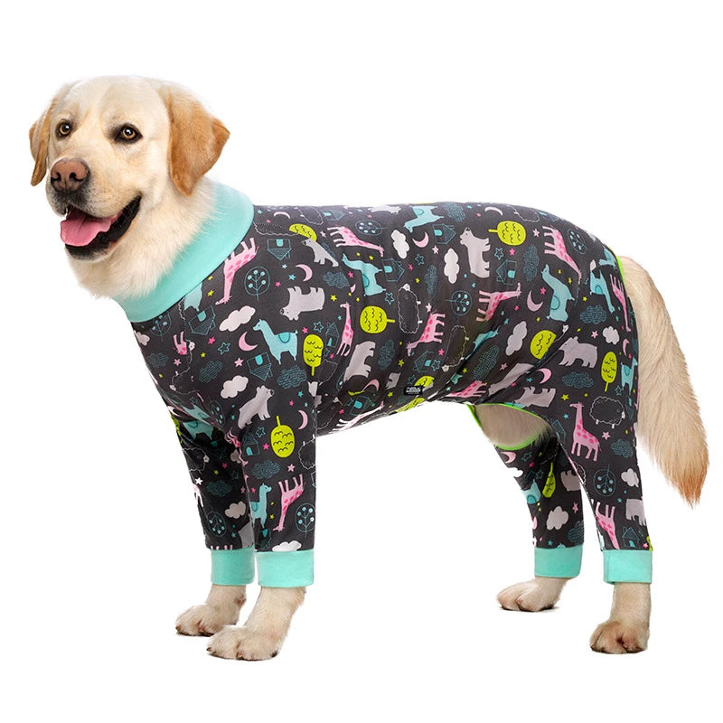 A golden retriever wearing a dark jumpsuit with a colorful cartoon animal print and light blue trim.
