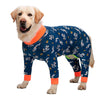 A golden Labrador wearing blue cartoon print cotton pajamas with orange trim.