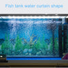 A glass fish tank displaying a vibrant underwater scene with aquatic plants and rocks.