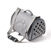 A gray breathable pet carrier bag with a paw print design and straps.