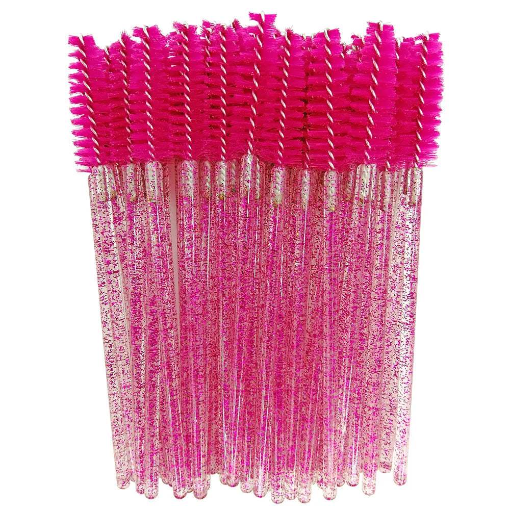 A bundle of bright pink disposable eyelash brushes with glittery pink stems.