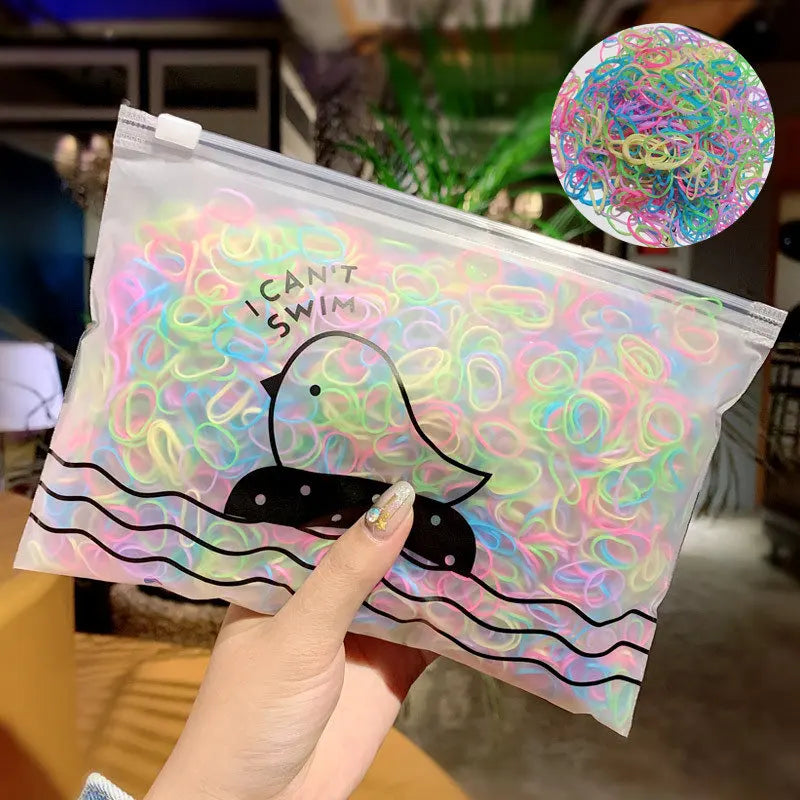 A clear plastic bag filled with colorful elastic hair bands shaped like ducks and swimming lines.