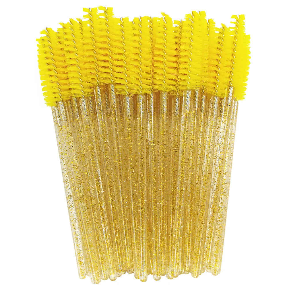 A bundle of yellow disposable eyelash brushes for makeup application