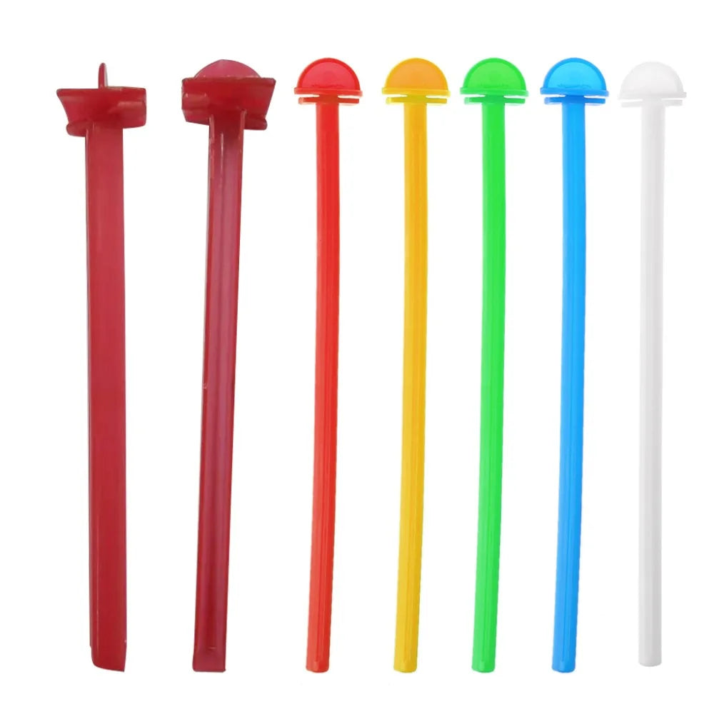 A set of five plastic bird perch stands in red, green, yellow, and white colors.
