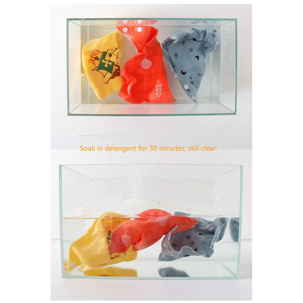 Three colored cotton pet bandanas soaking in water for cleaning.
